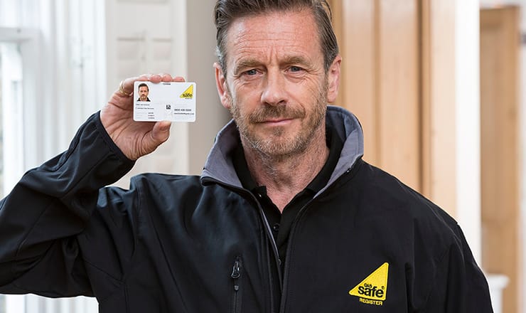 Gas Safe registered engineer showing his ID card